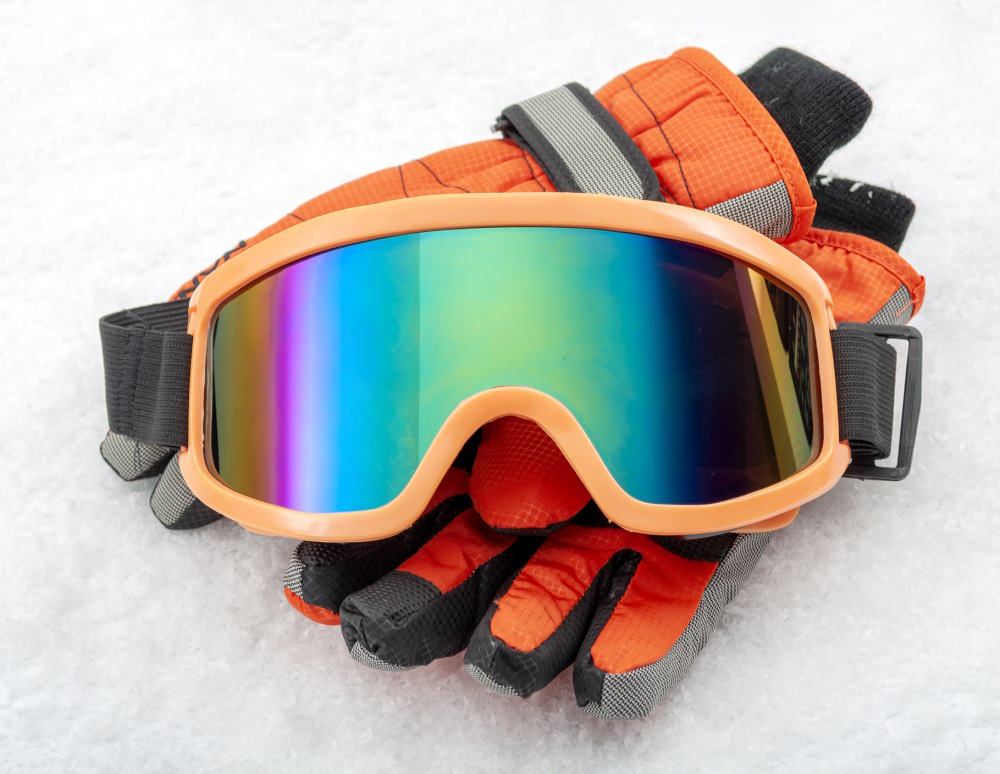 Image of Ski gloves and polarized goggles in the snow