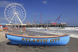 A boat that says "Atlantic City" on it with steel pier behind it in the background.